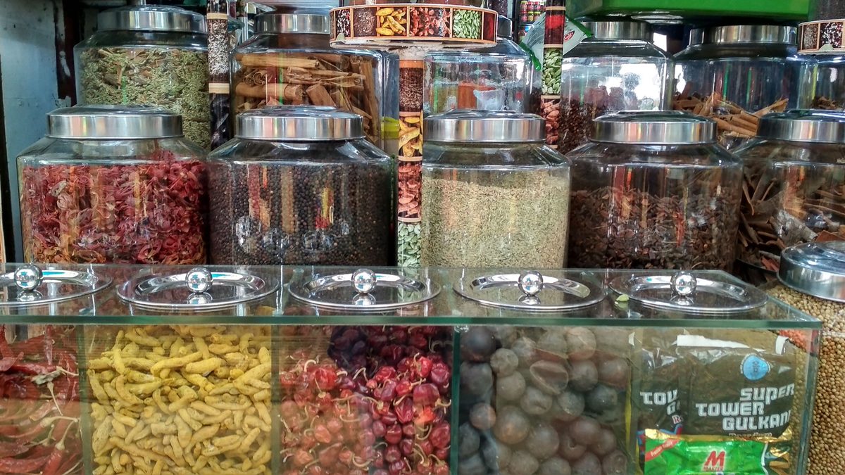 Assorted whole Indian spices at a market stall