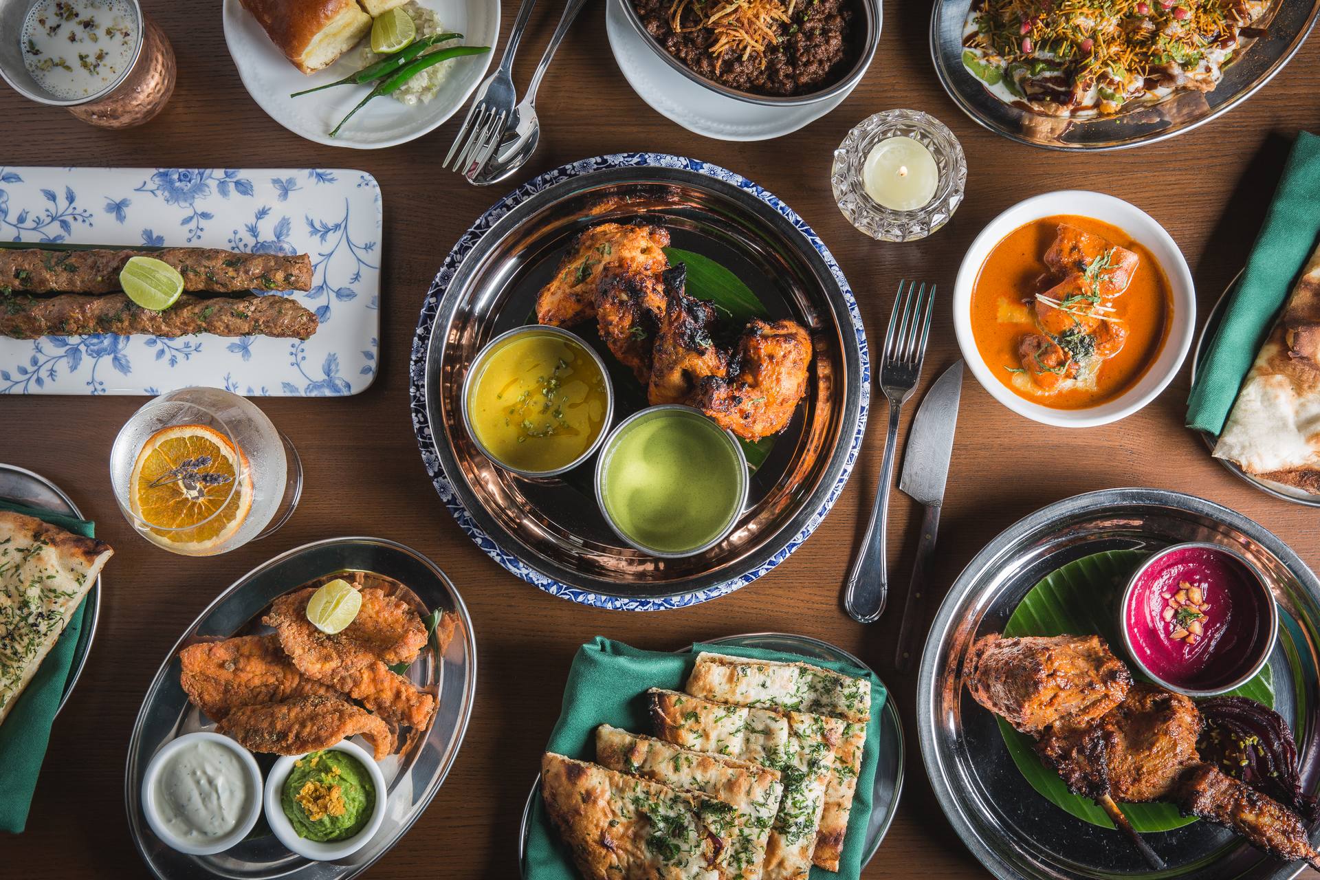 A generous spread of fusion Indian dishes including curry, naan, and tandoori favourites